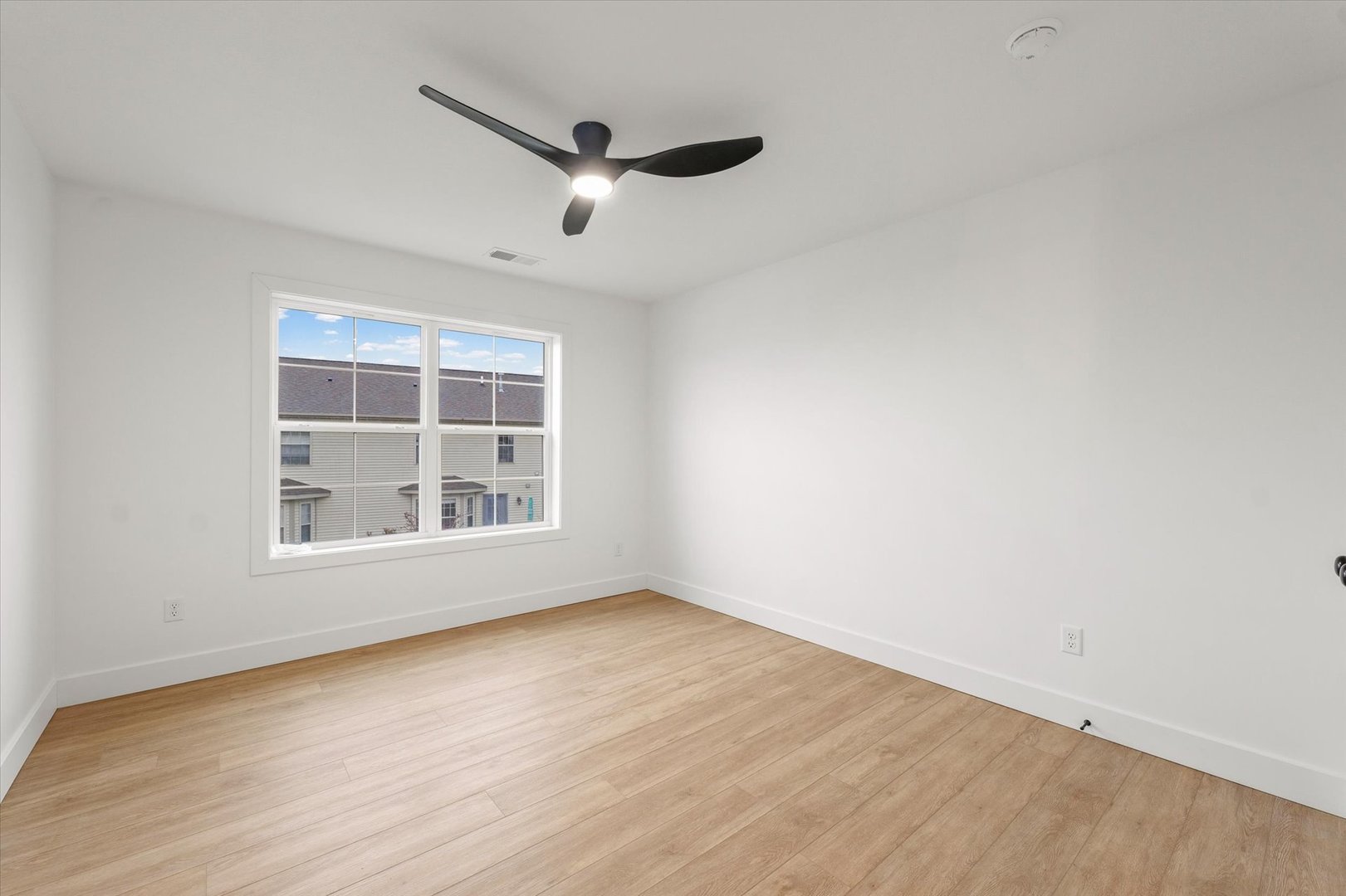 3712 Lighthouse Pointe Champaign, IL 61822 - Photo 18 of 36 an empty room with wooden floor cabinet and windows