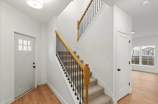 a view of entryway with wooden floor and stairs