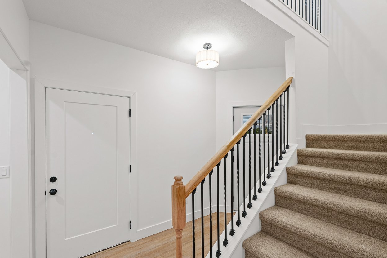 3712 Lighthouse Pointe Champaign, IL 61822 - Photo 22 of 36 a view of staircase with railing and a chandelier
