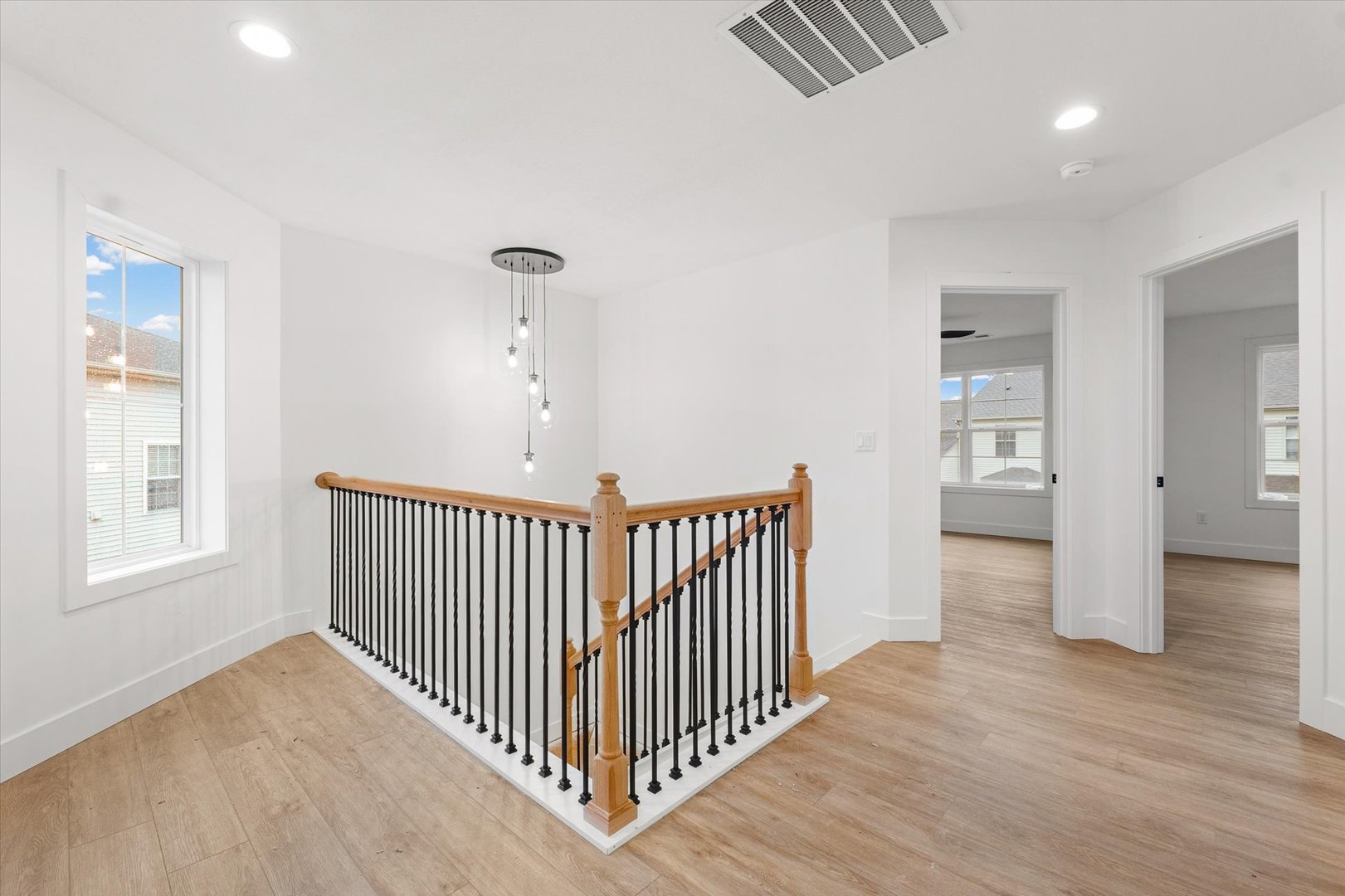 3712 Lighthouse Pointe Champaign, IL 61822 - Photo 23 of 36 a view of a hallway with wooden floor and windows