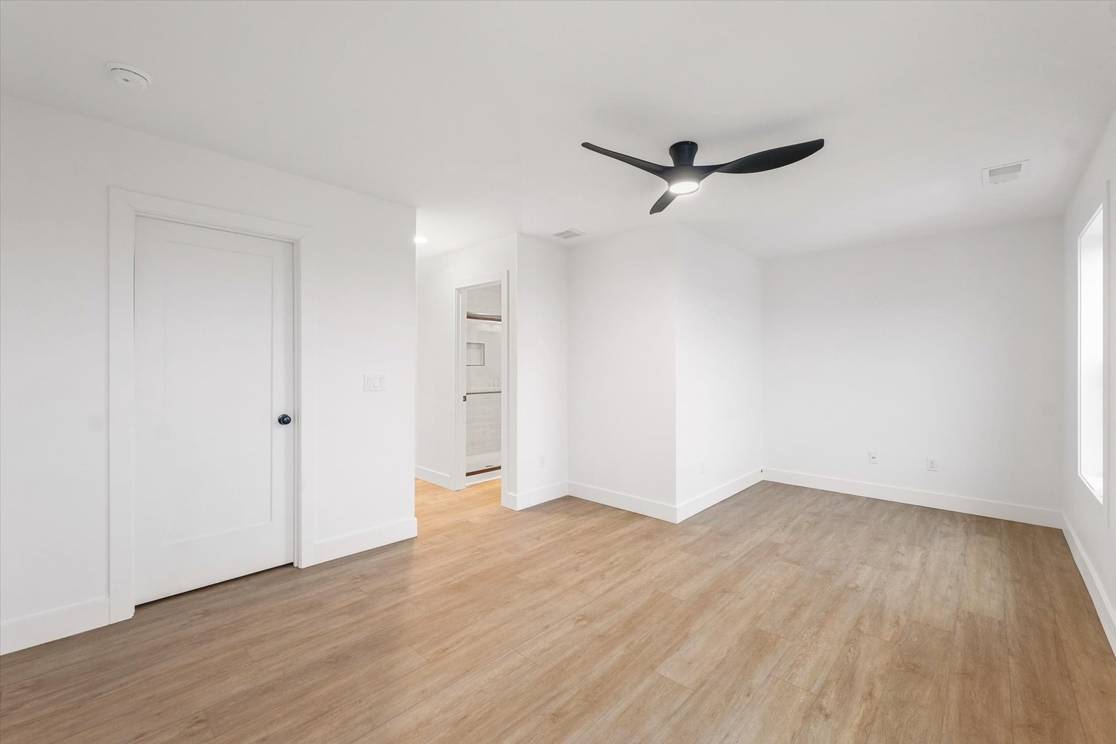 3712 Lighthouse Pointe Champaign, IL 61822 - Photo 31 of 36 an empty room with wooden floor a ceiling fan and windows