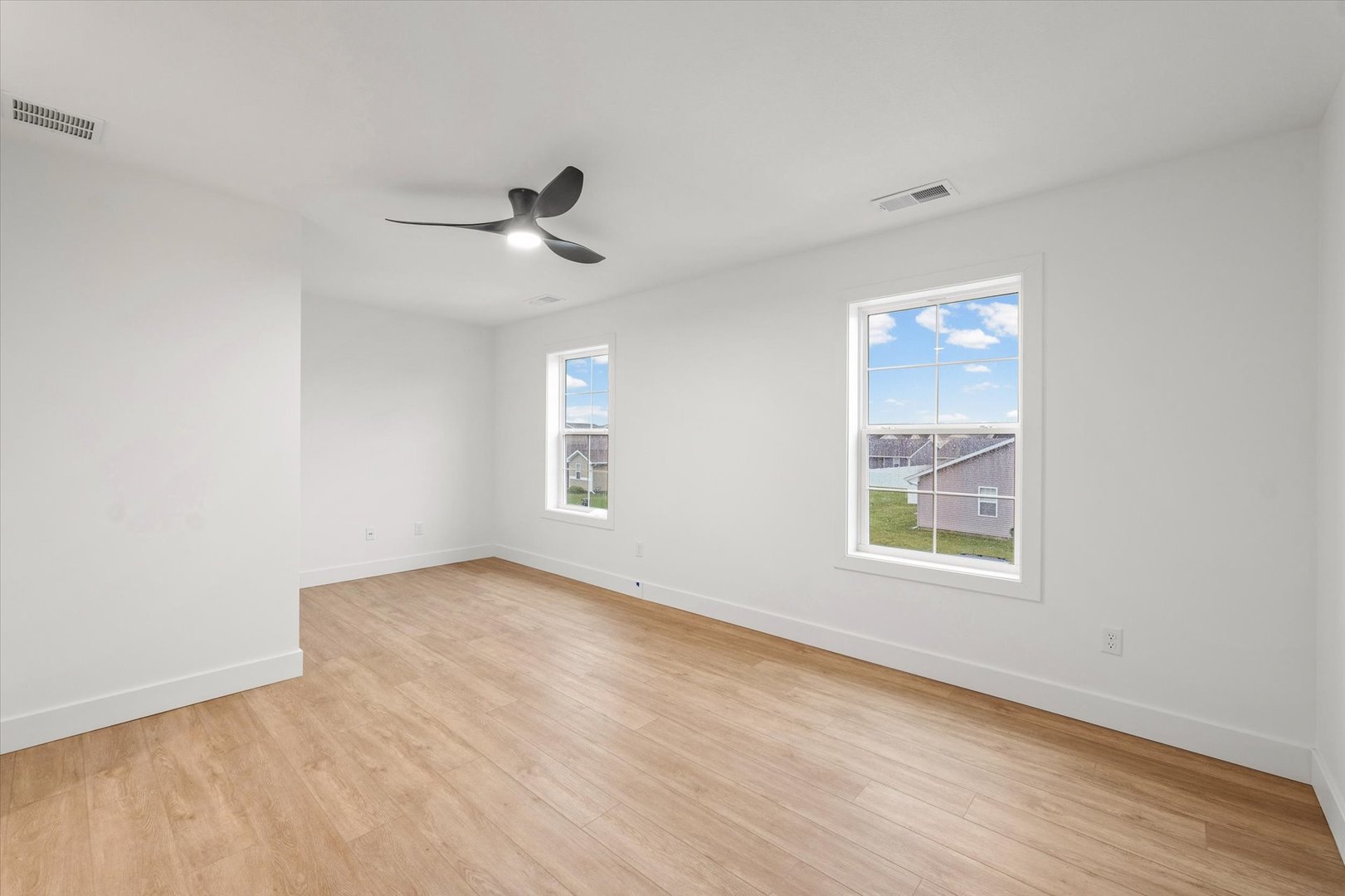 3712 Lighthouse Pointe Champaign, IL 61822 - Photo 32 of 36 an empty room with windows and fan