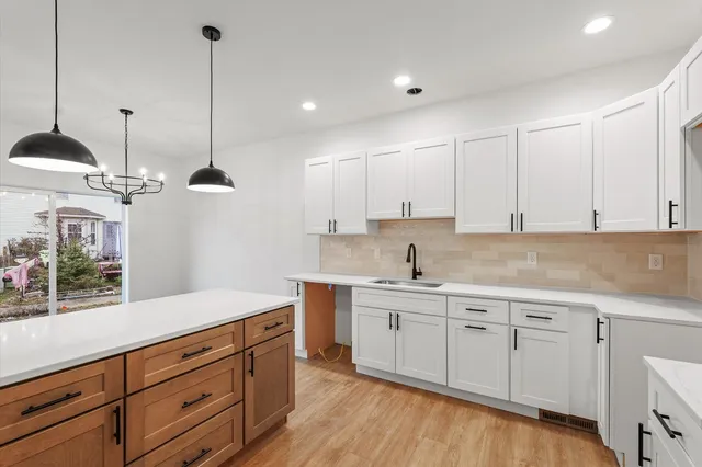 a kitchen with a sink window and cabinets