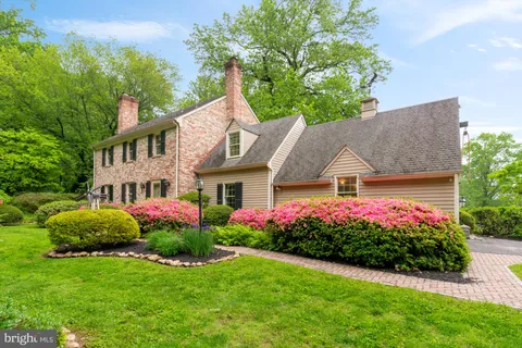 a view of a house with a big yard and potted plants