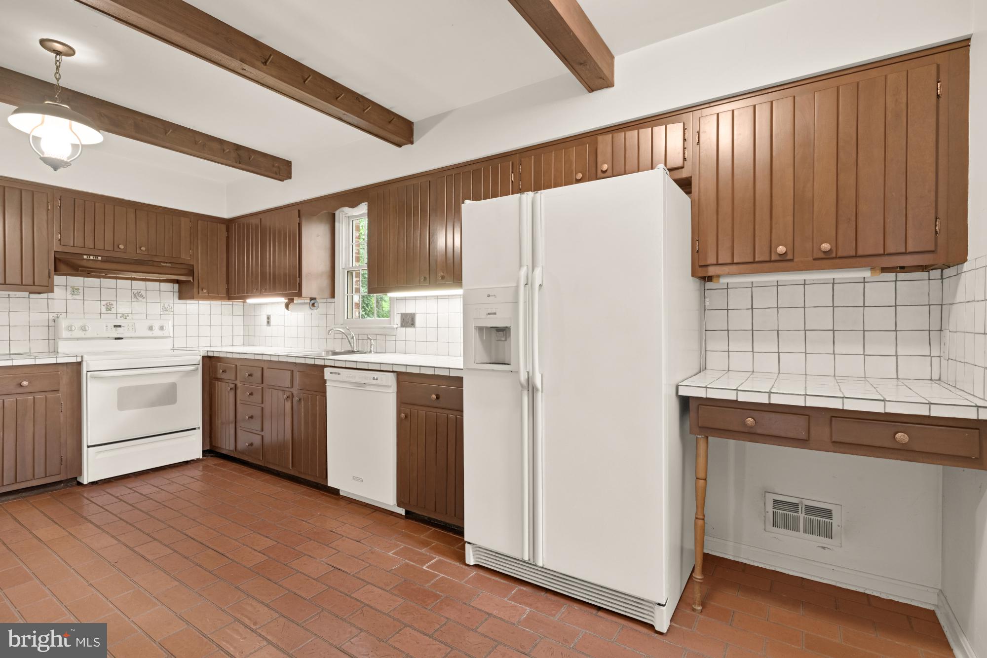 13001 Dulaney Valley Road Glen Arm, MD 21057 - Photo 21 of 52 a kitchen with a white refrigerator a sink dishwasher and wooden cabinets