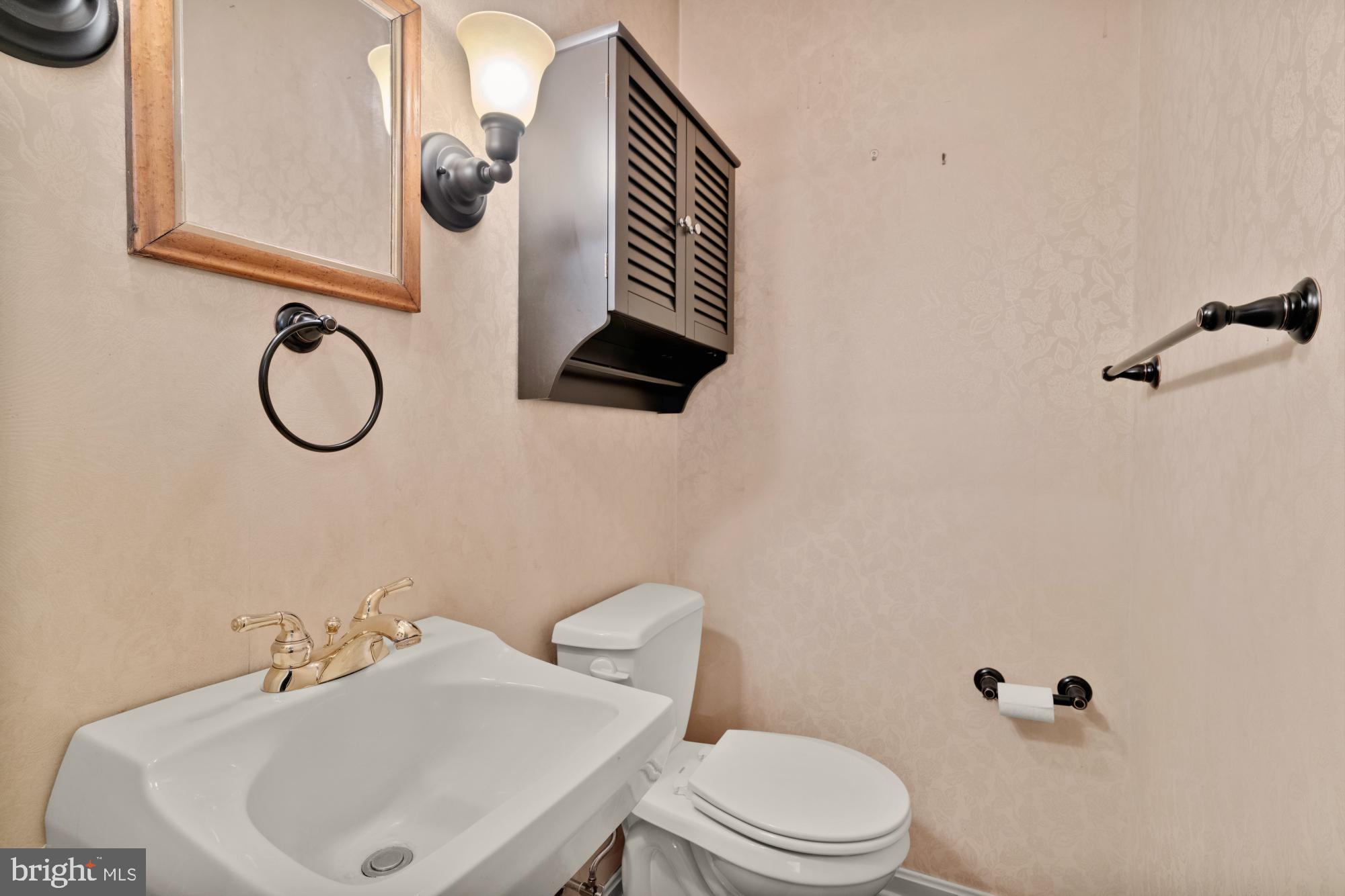13001 Dulaney Valley Road Glen Arm, MD 21057 - Photo 23 of 52 a bathroom with a sink toilet and mirror