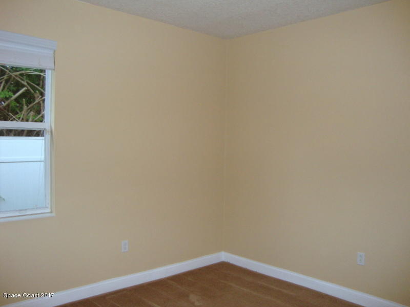 1441 Bridgeport Circle Rockledge, FL 32955 - Photo 16 of 26 a view of a small space with wooden floor and a window