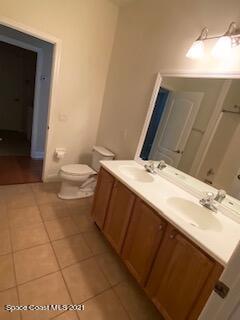 1441 Bridgeport Circle Rockledge, FL 32955 - Photo 18 of 26 a bathroom with a sink a toilet and a mirror