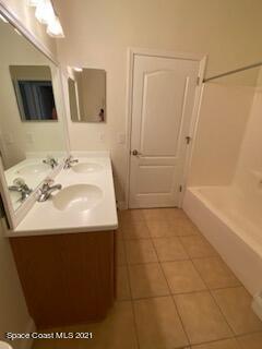 1441 Bridgeport Circle Rockledge, FL 32955 - Photo 19 of 26 a bathroom with a sink a toilet and a mirror
