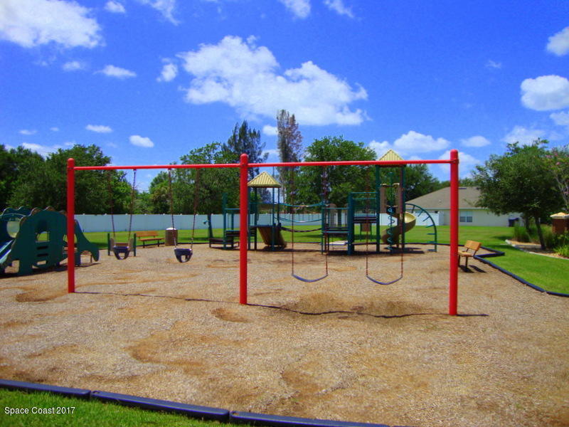 1441 Bridgeport Circle Rockledge, FL 32955 - Photo 25 of 26 a park view with a barbeque and bench