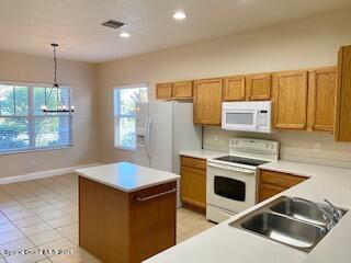 1441 Bridgeport Circle Rockledge, FL 32955 - Photo 7 of 26 a kitchen with stainless steel appliances granite countertop a sink stove and refrigerator