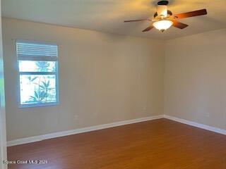 1441 Bridgeport Circle Rockledge, FL 32955 - Photo 9 of 26 an empty room with a window and a fan
