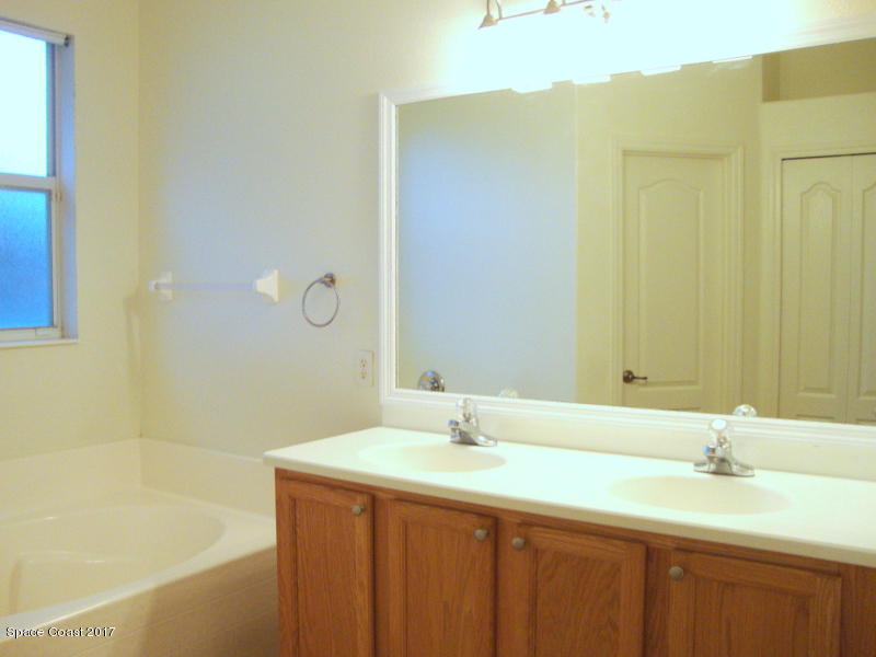 1441 Bridgeport Circle Rockledge, FL 32955 - Photo 10 of 26 a bathroom with a granite countertop sink and a bathtub
