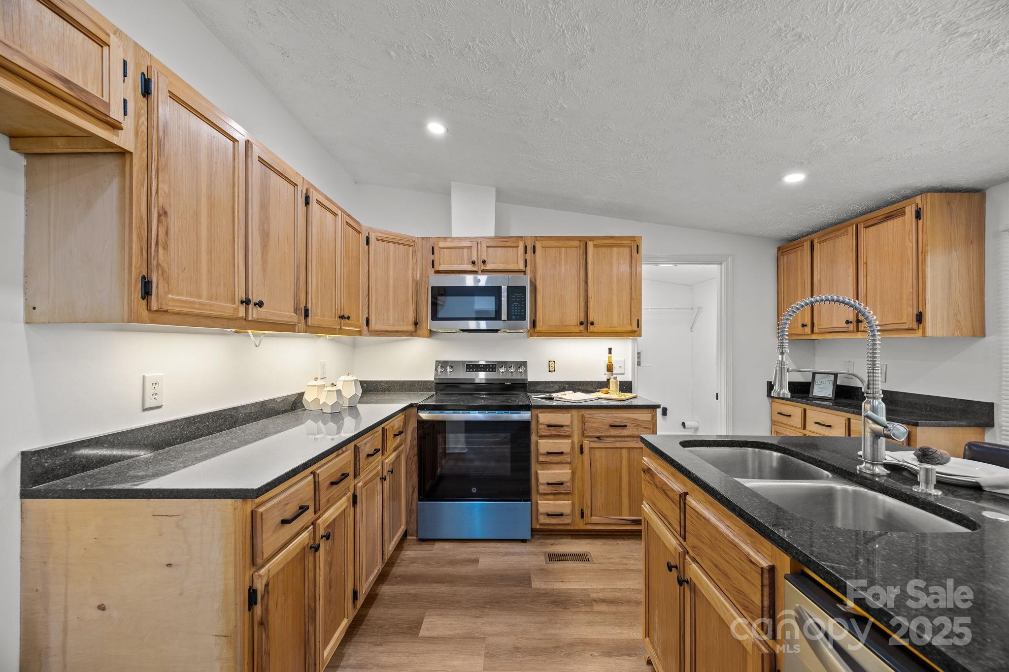 86 Tuts Terrace Sylva, NC 28779 - Photo 13 of 48 a kitchen with stainless steel appliances granite countertop a sink stove and refrigerator
