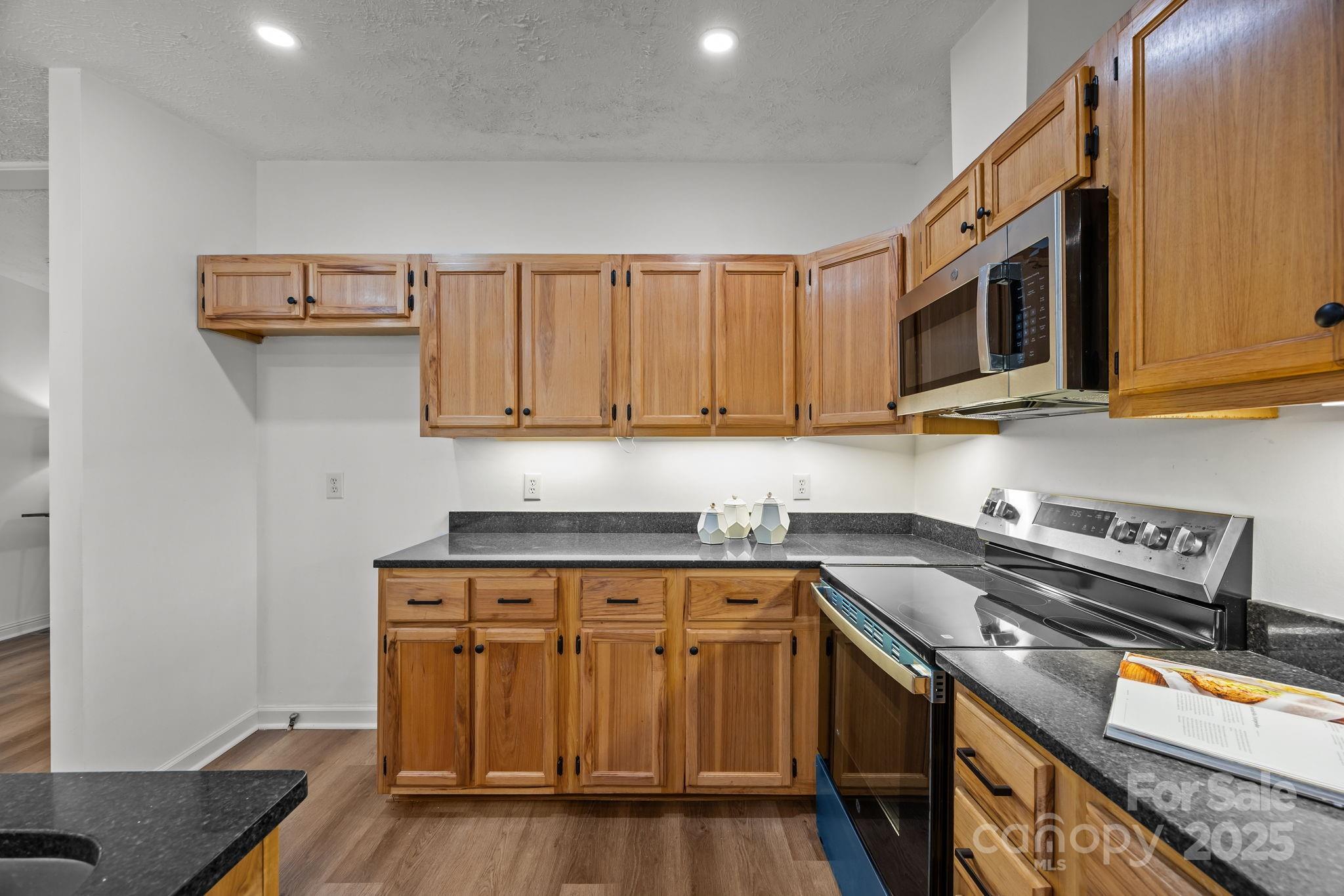 86 Tuts Terrace Sylva, NC 28779 - Photo 16 of 48 a kitchen with stainless steel appliances granite countertop a stove a sink and a microwave
