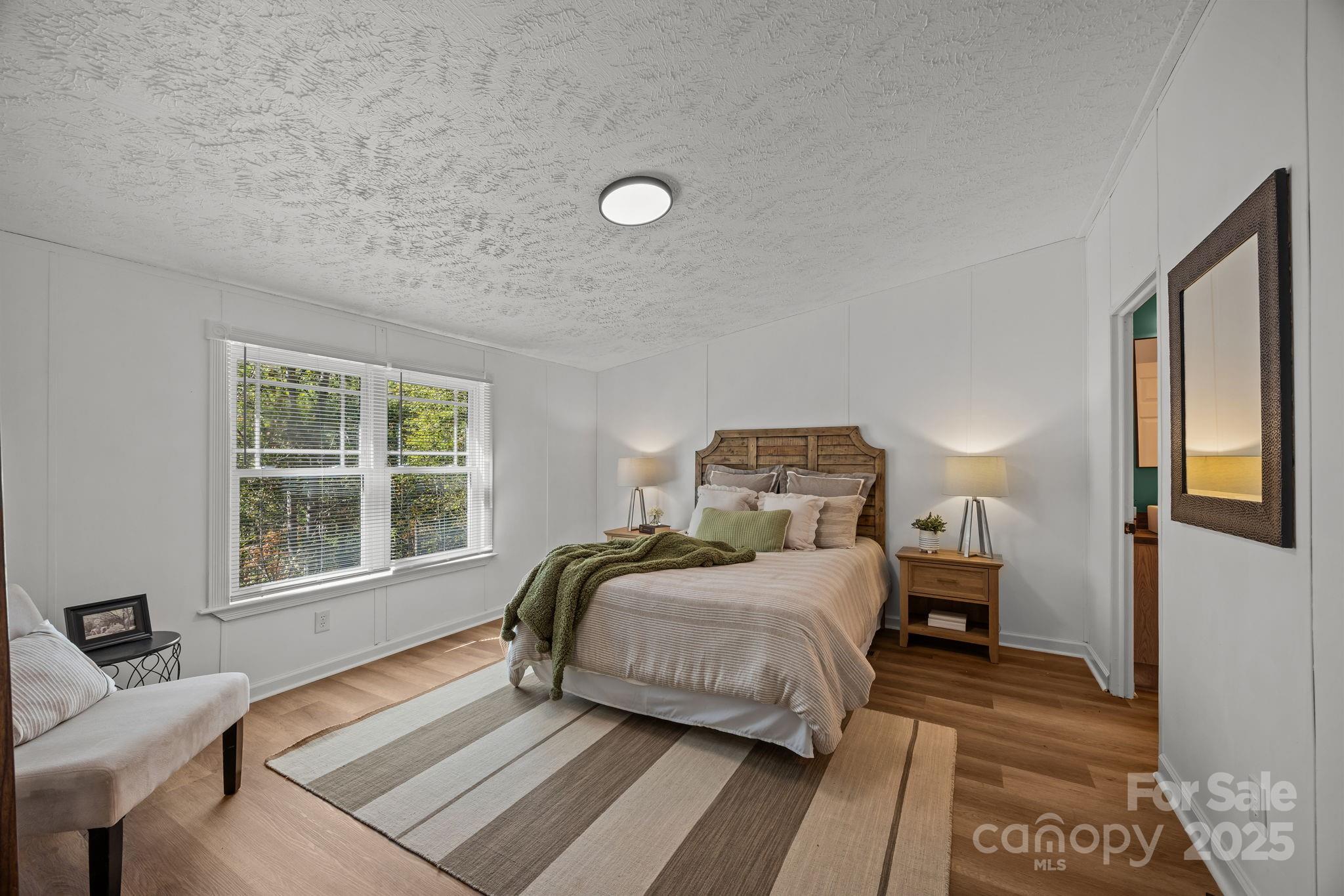 86 Tuts Terrace Sylva, NC 28779 - Photo 19 of 48 a bedroom with a bed and wooden floor