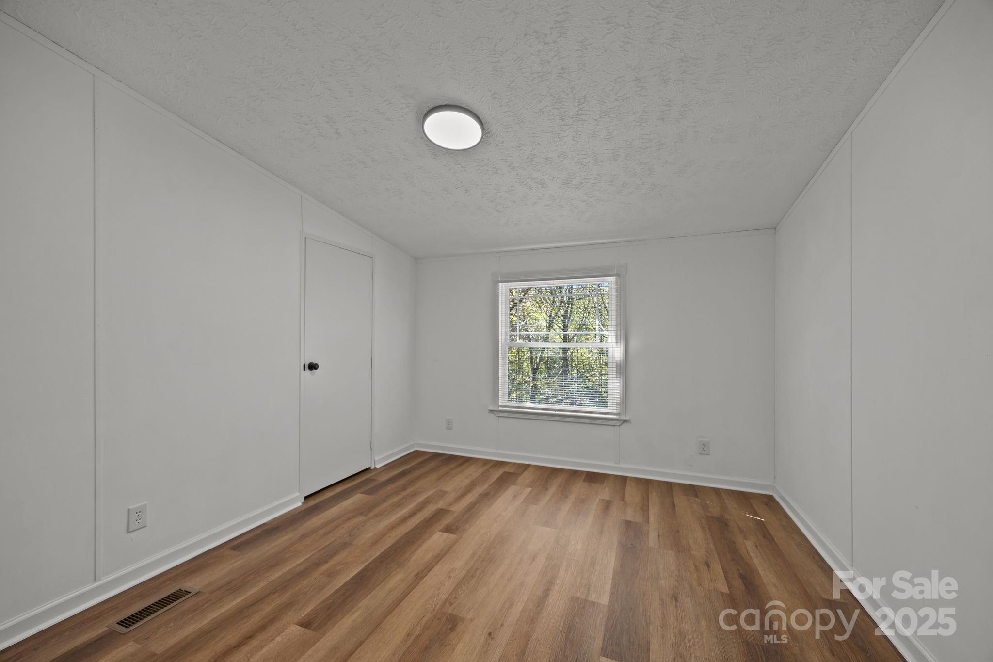 86 Tuts Terrace Sylva, NC 28779 - Photo 22 of 48 an empty room with wooden floor and windows