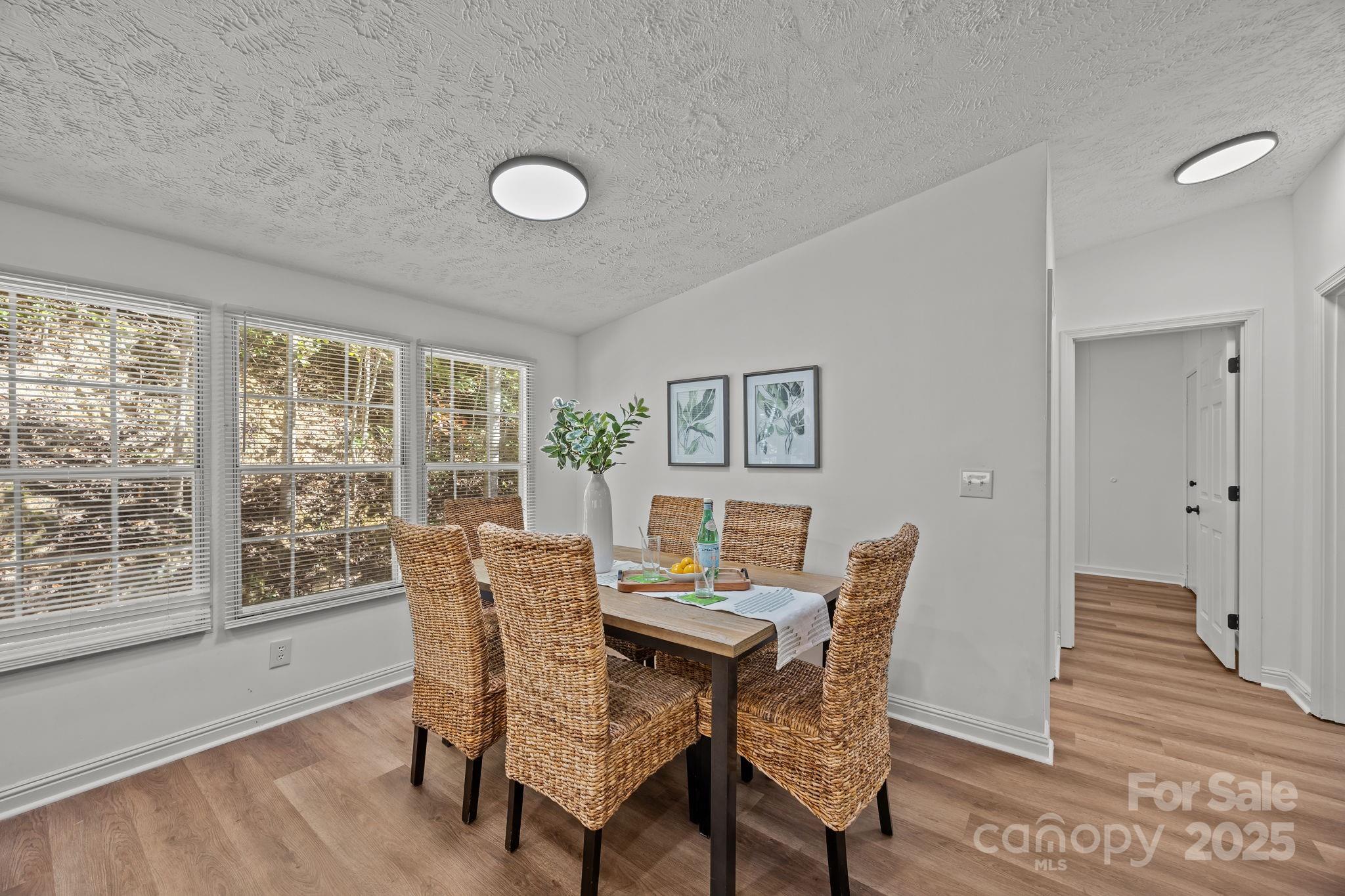 86 Tuts Terrace Sylva, NC 28779 - Photo 10 of 48 a view of a dining room with furniture window and wooden floor