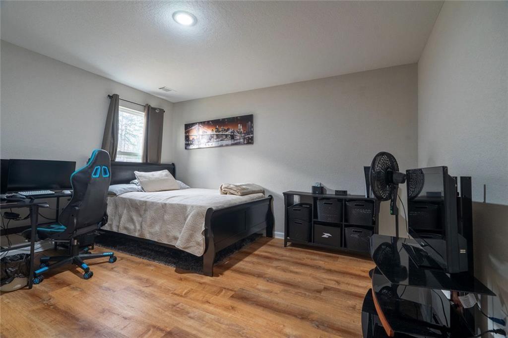 735 Walnut Creek Circle Pendergrass, GA 30567 - Photo 13 of 29 a bedroom with a bed and a flat screen tv