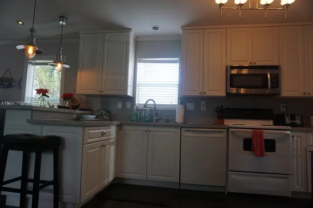 a living room with furniture a flat screen tv and a window