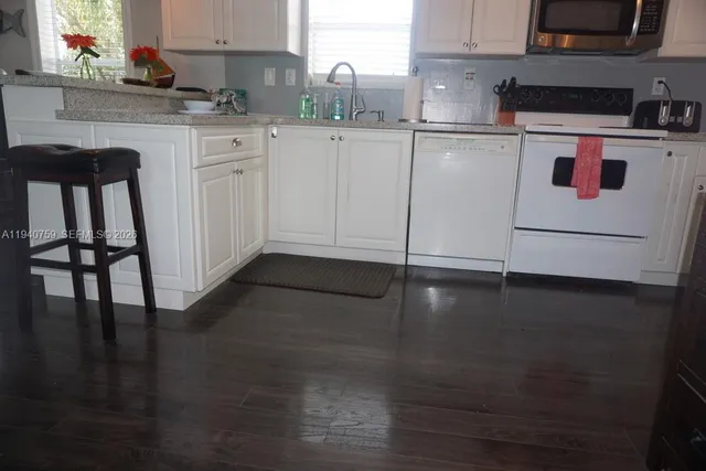 a living room with furniture rug and window