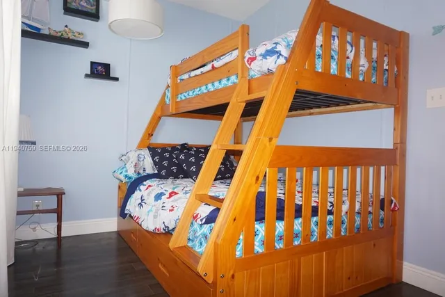 a dining room with furniture a rug a mirror and a chandelier