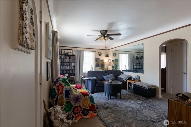 a living room with furniture a window and gym equipment