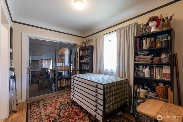 a bedroom with a bed and a book shelf
