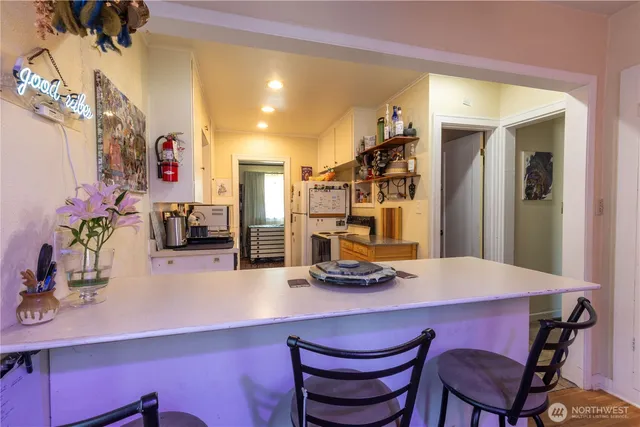 a dining room with furniture and wooden floor