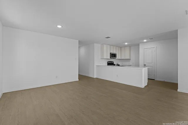 a view of kitchen with kitchen island sink stainless steel appliances and cabinets