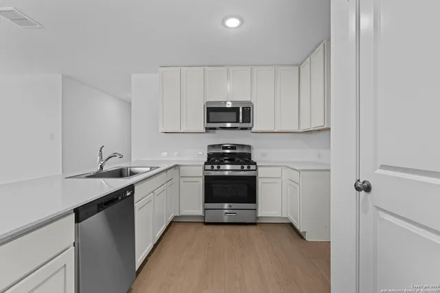 a kitchen with a sink and a stove top oven
