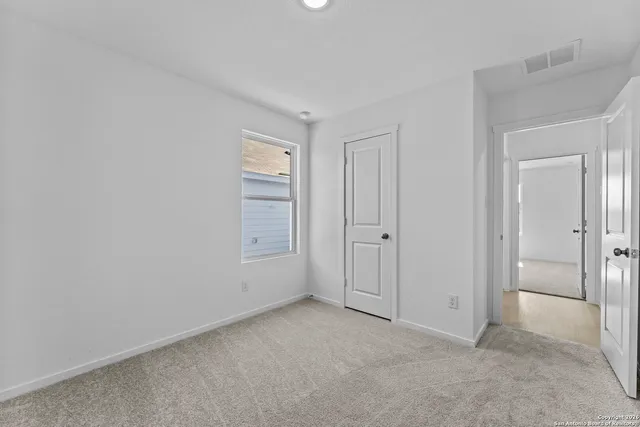 a view of an empty room and closet area