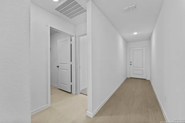 an empty room with wooden floor