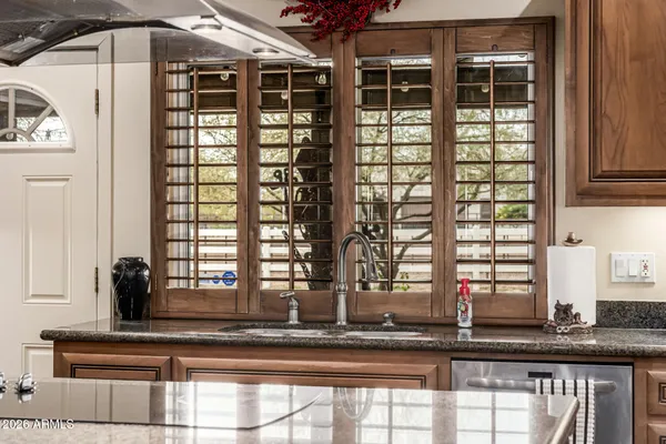 a living room with furniture a rug and wall paintings