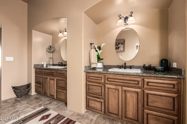 a roof deck with table and chairs and potted plants