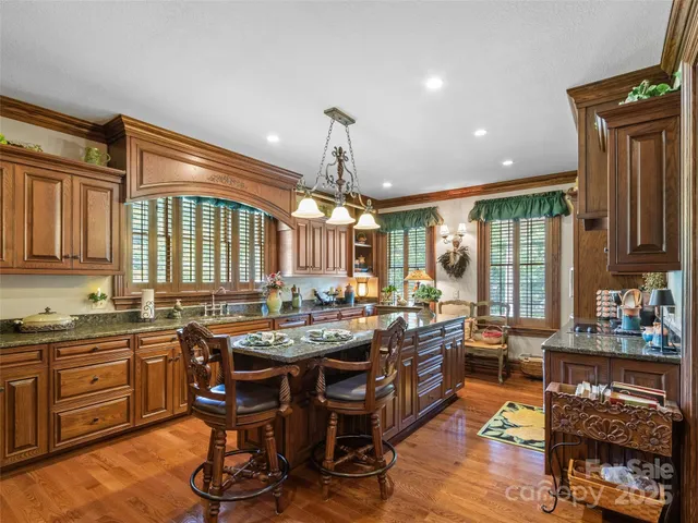a living room with furniture a fireplace and a large window