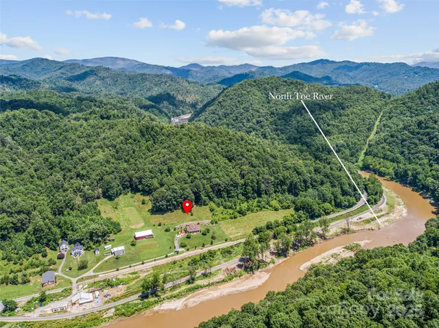 a view of a brick house with a chairs and table in a patio