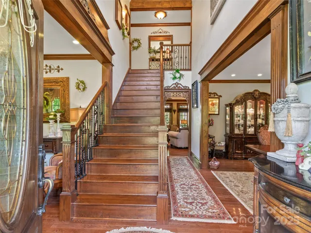 a view of a dining room with furniture chandelier and wooden floor