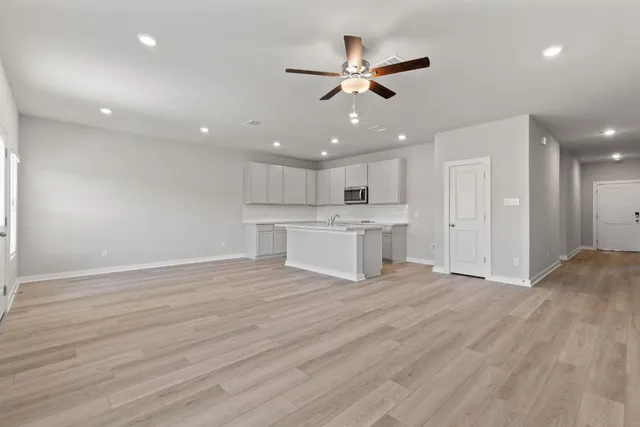 a view of a kitchen with a dishwasher cabinets and wooden floor