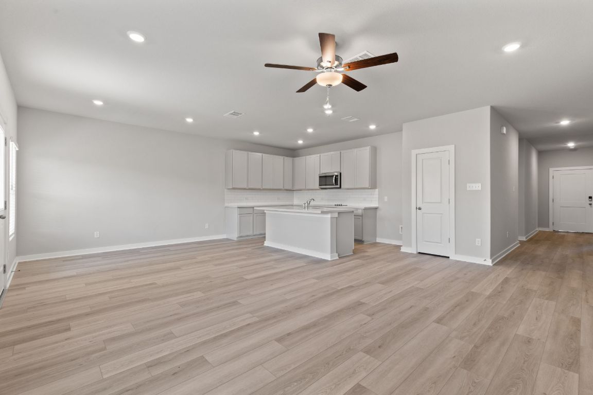 13617 Gray Landing Drive Elgin, TX 78621 - Photo 11 of 29 a view of a kitchen with a dishwasher cabinets and wooden floor