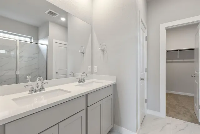 a bathroom with a sink double vanity and a mirror