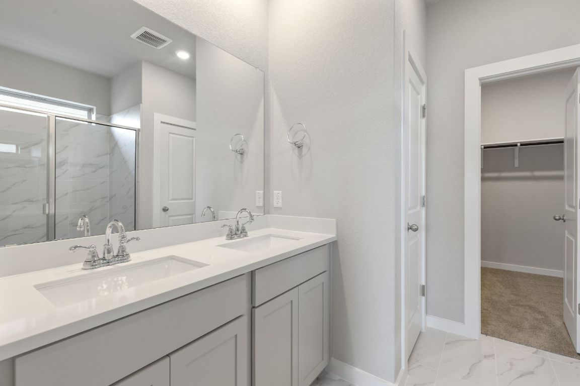 13617 Gray Landing Drive Elgin, TX 78621 - Photo 18 of 29 a bathroom with a sink double vanity and a mirror