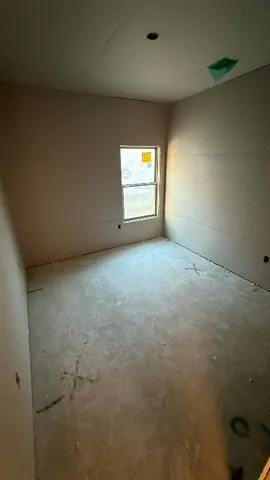 an empty room with a empty space and windows