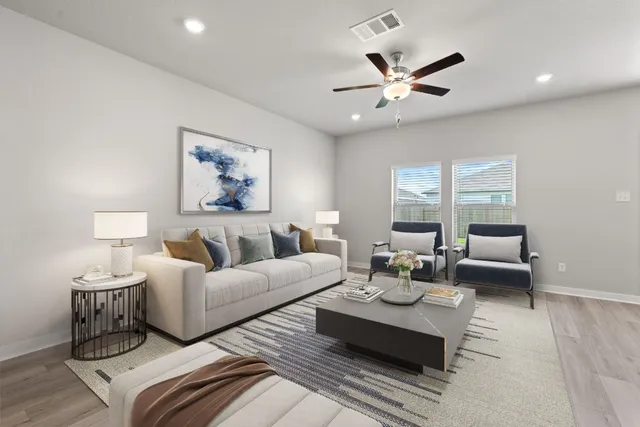 a living room with furniture and white walls