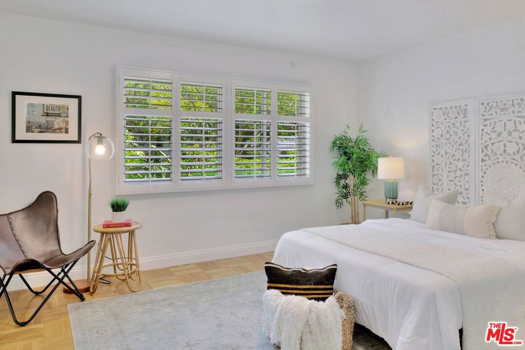5372 Village Los Angeles, CA 90016 - Photo 12 of 28 a bedroom with a bed and a chair with the potted plant