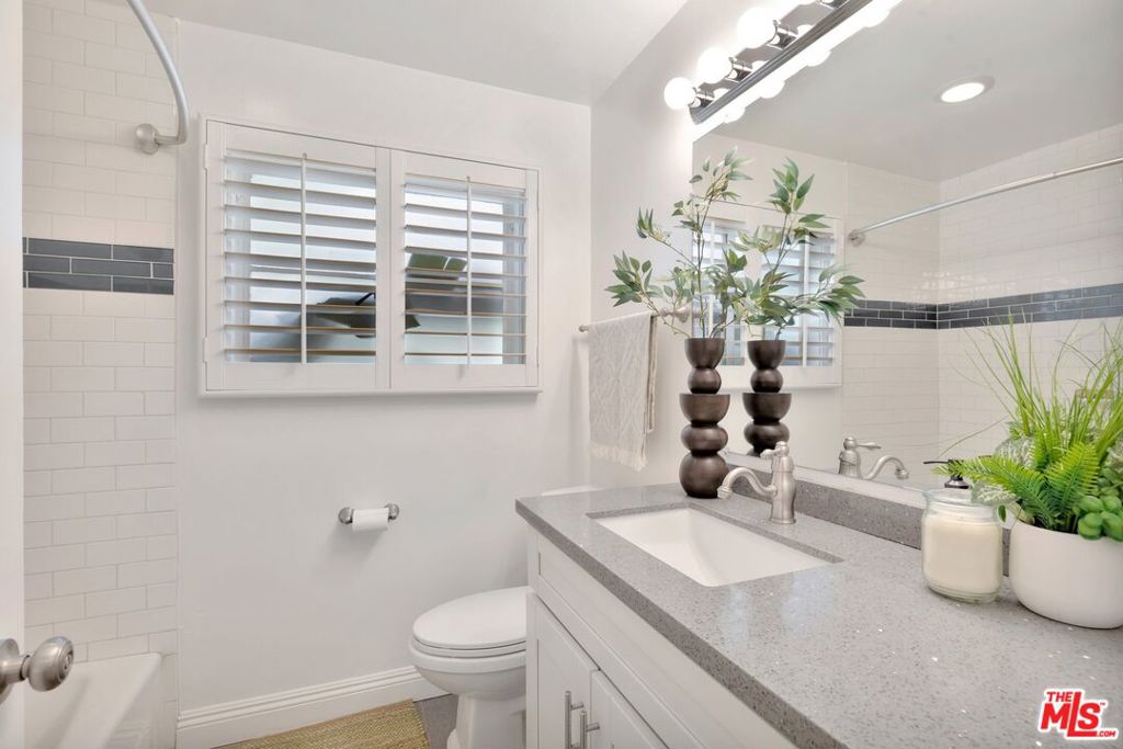 5372 Village Los Angeles, CA 90016 - Photo 13 of 28 a bathroom with a sink a toilet and a mirror