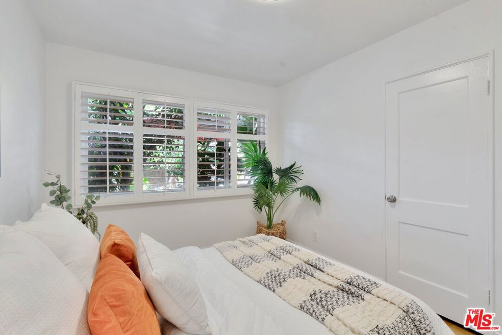 5372 Village Los Angeles, CA 90016 - Photo 16 of 28 a bed sitting in a bedroom next to a window