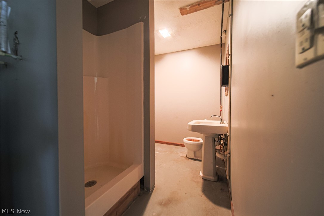 Plum Road Kimbolton, OH 43749 - Photo 7 of 50 Full bathroom with unfinished concrete flooring and a shower stall