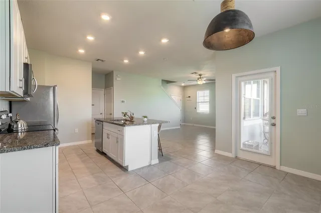 a kitchen with a sink and refrigerator