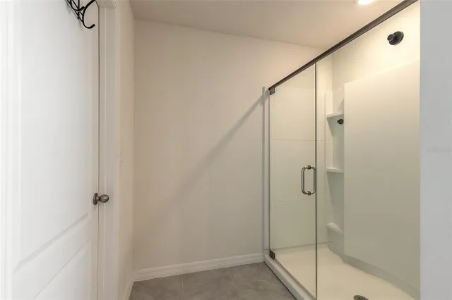a bathroom with a glass shower door
